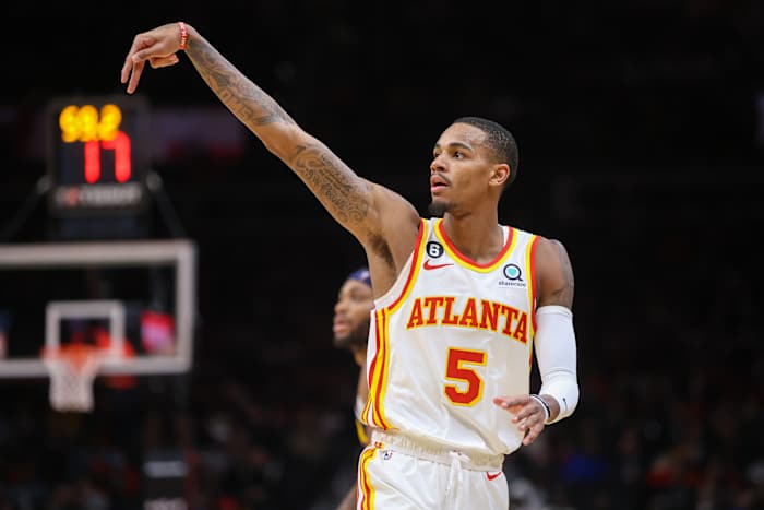 Hawks guard Dejounte Murray holds his form after making a shot.